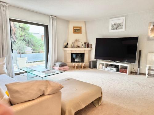a living room with a large flat screen tv at Villasonboard 2 Bed Condo Beach Seaview Greek Riviera Vouliagmeni in Athens
