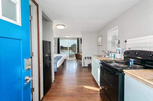 a kitchen with a sink and a stove top oven at Breakwater Resort in Grayland