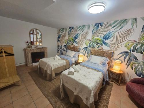 a room with two beds and a fireplace in it at Villa Mogaren in Vega de San Mateo