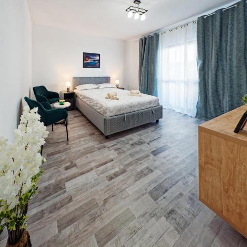 a bedroom with a bed and a desk and a chair at FLH - Studio Escape Din Munti in Sînpetru