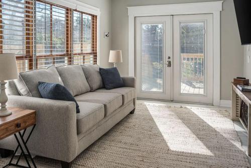 a living room with a couch and windows at Old Dauphin Way Historic Home - Unit 6 in Mobile