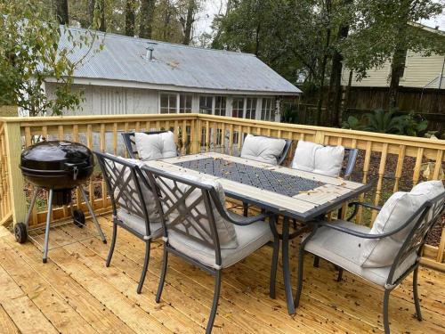 a table and chairs on a deck with a grill at Old Dauphin Way Historic Home - Unit 6 in Mobile