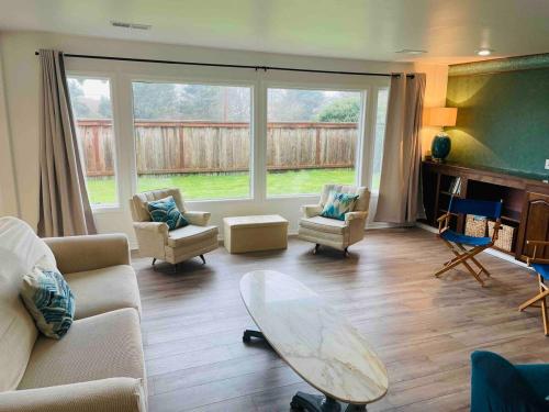 a living room with a couch and chairs and a table at Surfside Beach House near Ancient Redwoods in Smith River