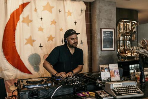 a man standing behind a counter in a room at Drifter Christchurch in Christchurch