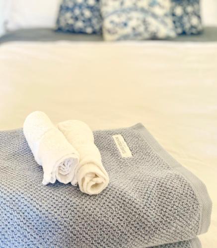 a couple of towels sitting on top of a bed at Kent Street Retreat in Brisbane