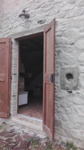 an open door in a stone building with a room at Borgo Pizzicarè in Vado