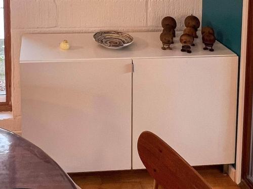 a small white cabinet with two teddy bears on top of it at 6 person holiday home in Asperup in Asperup