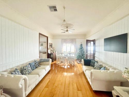 a living room with two couches and a christmas tree at Kent Street Retreat in Brisbane