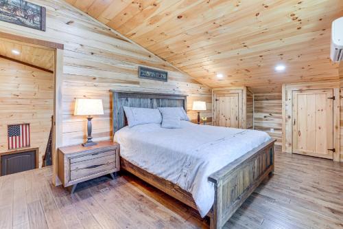 a bedroom with a bed in a wooden cabin at 12 Mi to Tryon International Forest City Gem! in Forest City