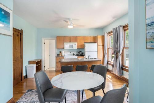 a kitchen and dining room with a table and chairs at Grand Harbor Apartments 3 - 200 in Grand Haven