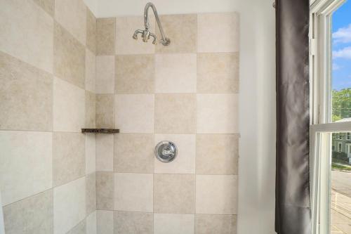 a bathroom with a shower with a glass door at Grand Harbor Apartments 3 - 200 in Grand Haven