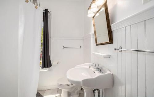 a white bathroom with a sink and a toilet at Grand Harbor Apartments 3 - 200 in Grand Haven