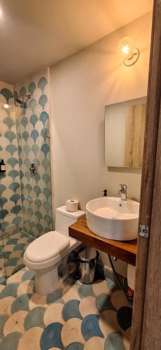 a bathroom with a toilet and a sink at Casa 8 in Guadalajara