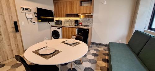 a small kitchen with a white table and chairs at Casa 8 in Guadalajara