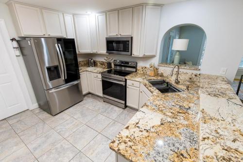 a kitchen with marble counter tops and stainless steel appliances at The Herons Nest in Irmo