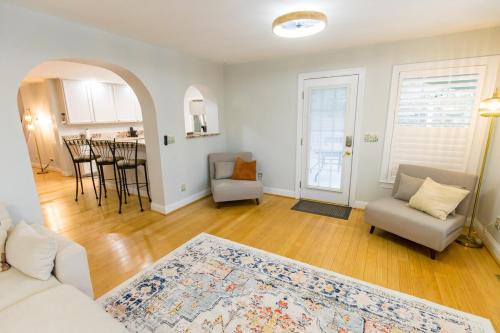 a living room with a couch and chairs and a kitchen at The Herons Nest in Irmo