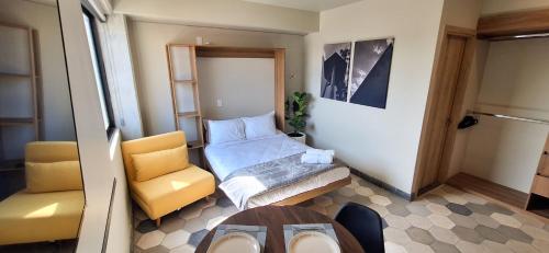a small room with a bed and a chair at Casa 8 in Guadalajara