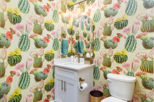 a bathroom with a cactus wallpaper with a toilet at Wild West Oasis - Experienced Hosts, 2 King Suites in Hurricane