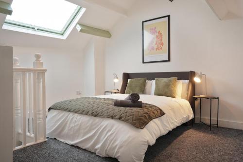 a bedroom with a bed with a teddy bear on it at Modern 2 Bed Apartment in Hillsborough with FREE Secure Parking - Hosted by Stay Host Save in Hillsborough