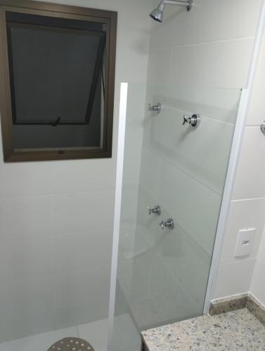 a bathroom with a shower with a television in it at Apartamento Completo em Cabo Frio in Cabo Frio