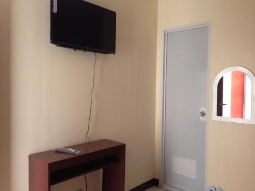 a room with a flat screen tv on the wall at Haus Of Tubo Davao in Davao City