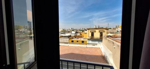 a view of a city from a window at Casa 8 in Guadalajara