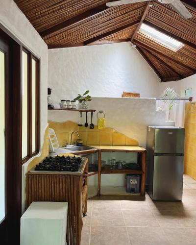 a kitchen with a stove and a sink at Pachamama Tropical Garden Lodge in Carmen