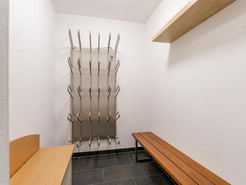 a room with a wooden bench next to a wall at Ferdinand A in Hirnreit