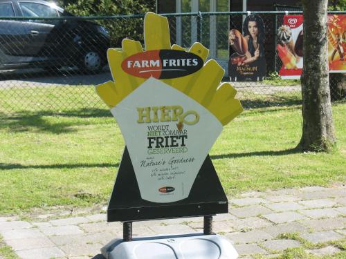 a sign for a food truck in a park at Cabin in Tzummarum with Pool and Tennis Court in Tzummarum