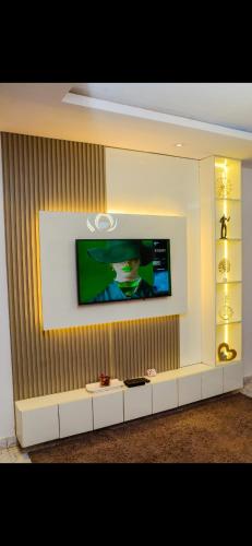 a television on a wall in a living room at Exquisitely and luxury furnished apartment in Sangotedo
