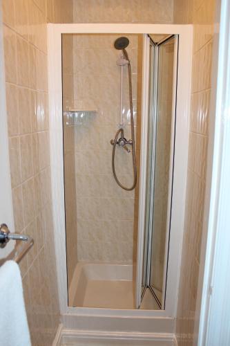 a shower with a glass door in a bathroom at The Moray House in Blackpool