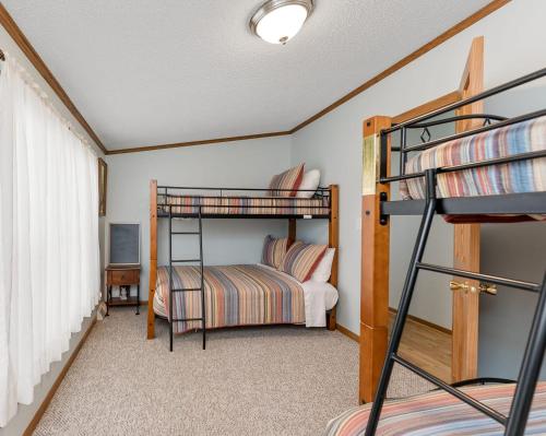 a bedroom with two bunk beds and a bed at Lakefront Retreat in a Serene Country Setting in Pullman