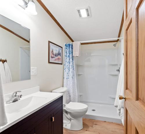 a white bathroom with a sink and a toilet at Lakefront Retreat in a Serene Country Setting in Pullman