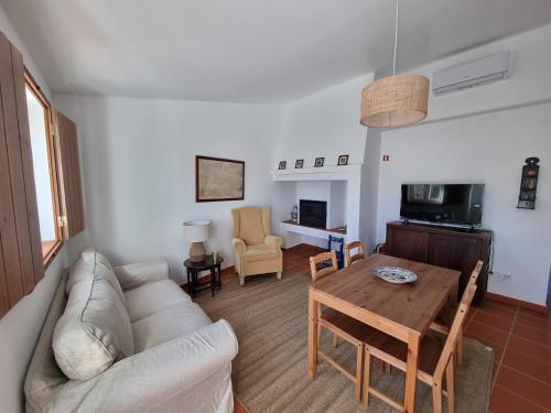 a living room with a couch and a table at Herdade do Vidigal in Montemor-o-Novo