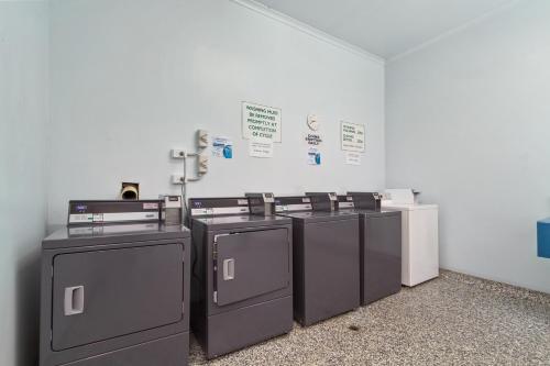 a group of three washers and dryers in a room at Waters Edge Holiday Park in Lakes Entrance