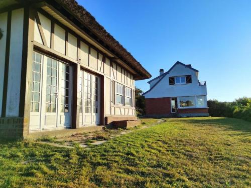 a house with a grass yard in front of it at Holiday home for 8 people in Veulettes-sur-Mer