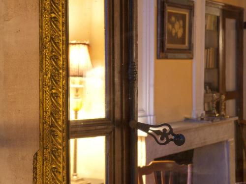 a mirror in a room with a window and a fireplace at Provençal charm Comfortable Vacation Home in Avignon