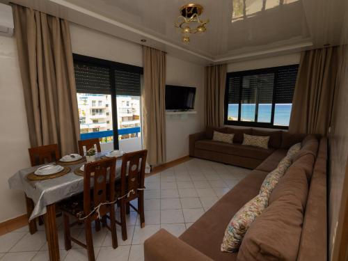 a living room with a large couch and a table at Luxury Vista Mar Apartment in Martil