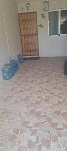 an empty room with a door and a tile floor at Hostal Mari sabina in Bucerías