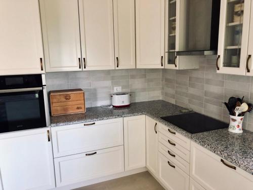 a kitchen with white cabinets and a counter top at Villa Bonaca in Mrljane