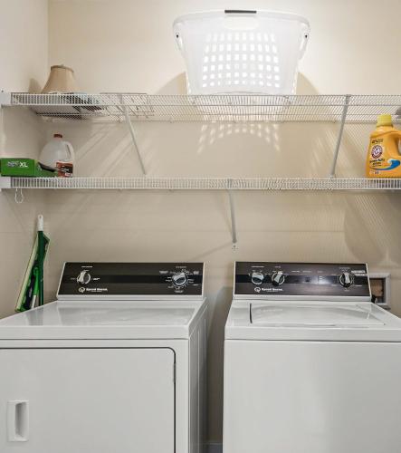 a kitchen with a stove and a washer and dryer at Open Concept Lakefront Home with Rec Room and Fire Pit in Grand Junction