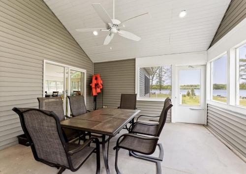a dining room with a table and chairs and a ceiling fan at Open Concept Lakefront Home with Rec Room and Fire Pit in Grand Junction