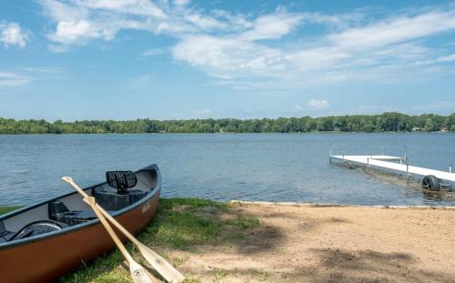 a boat sitting on the shore of a lake at Open Concept Lakefront Home with Rec Room and Fire Pit in Grand Junction