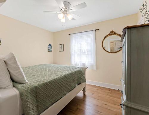 a bedroom with a bed and a ceiling fan at Spacious Lakefront Home with Firepit Near South Haven in Grand Junction