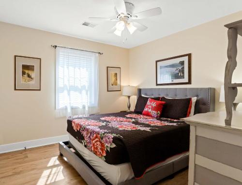 a bedroom with a bed and a ceiling fan at Spacious Lakefront Home with Firepit Near South Haven in Grand Junction