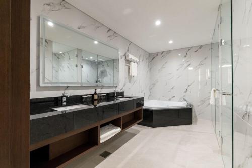 a bathroom with a sink and a mirror at Stanford hotel Andong in Andong