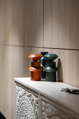 a group ofcolored vases sitting on top of a table at Nile pearl Cairo Maadi Apartment luxury in Cairo