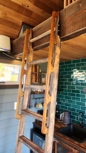 a wooden ladder in a kitchen with a sink at Appledore - Cabin in the Valley in Glen Huon