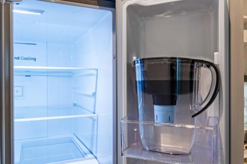 an empty refrigerator with a glass container in it at King Bed EVCharger Sleeps 8 Balcony Laundry in San Diego