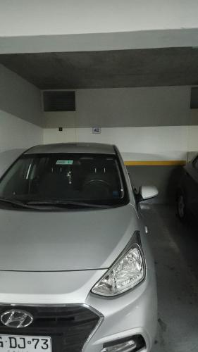 a silver car parked in a parking garage at departamento pedro prado cercano al mall zofri in Iquique